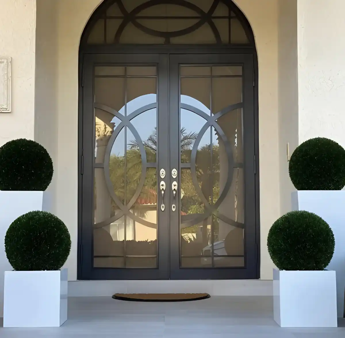 Decorative impact double entry doors with circular ironwork South Florida home