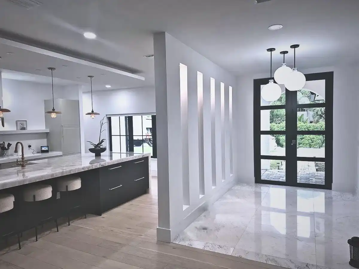 Black-framed impact glass front entry door in modern South Florida home