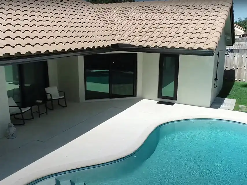 Impact sliding glass doors on South Florida pool home with tile roof
