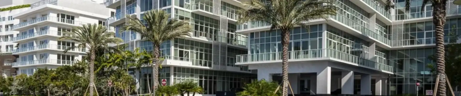 Luxury Miami building with floor-to-ceiling impact glass windows and balconies