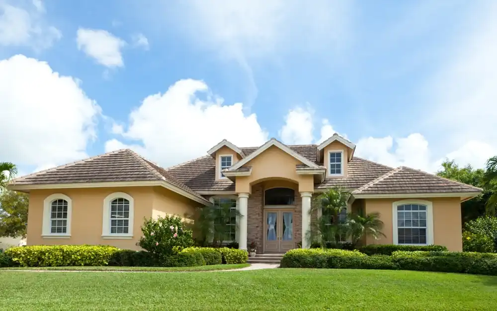 South Florida home with tile roof, impact windows, and double entry doors