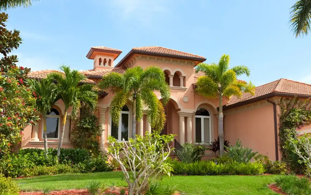 Mediterranean South Florida home with terracotta clay tile roof and arched windows
