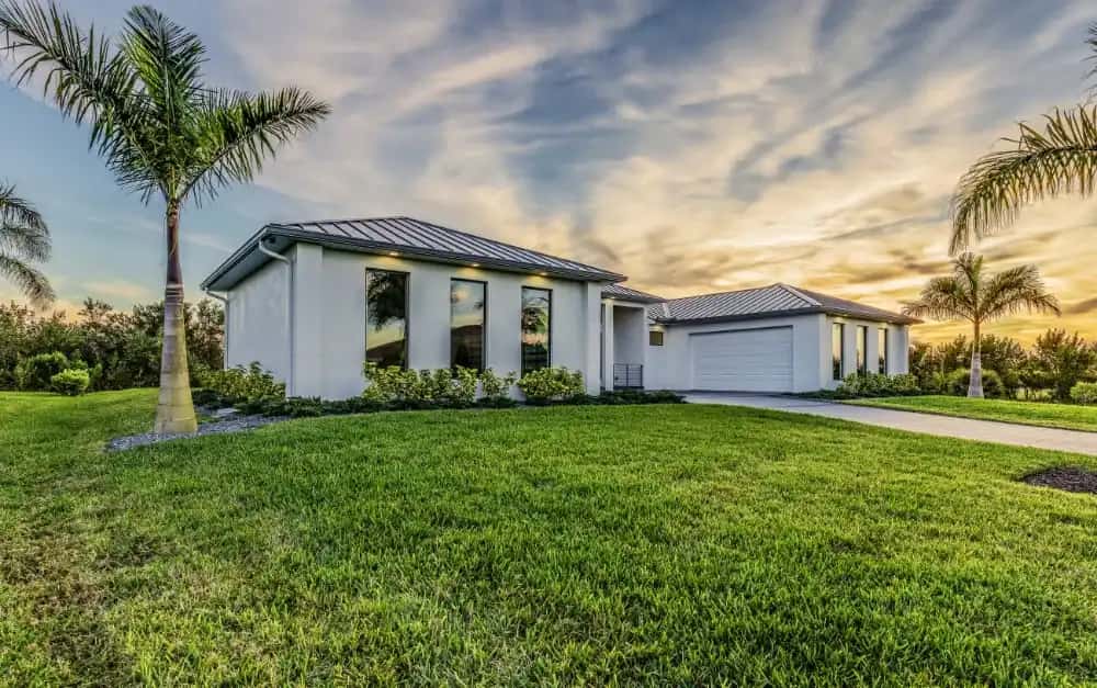 Modern Florida home with standing seam metal roof and impact windows