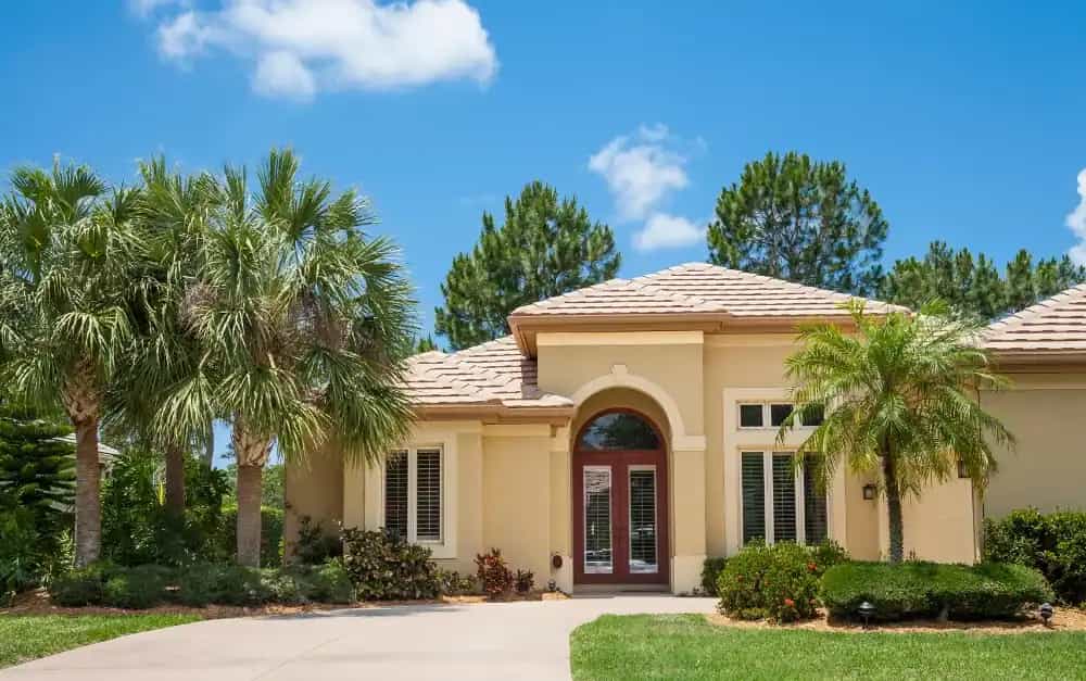 Palm Beach County home with barrel tile roof and impact entry doors