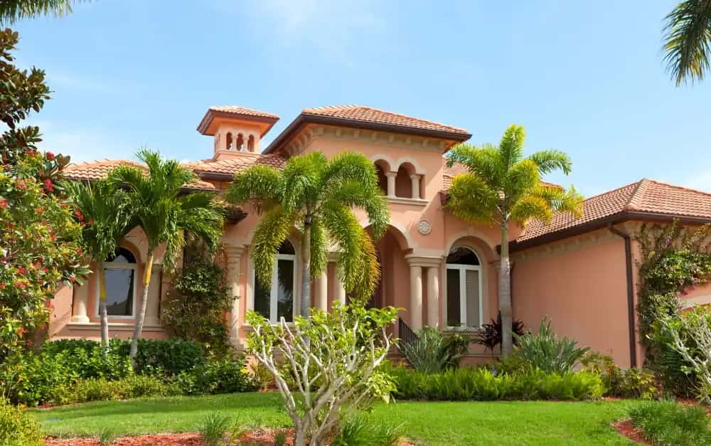 Mediterranean South Florida home with terracotta clay tile roof and arched windows