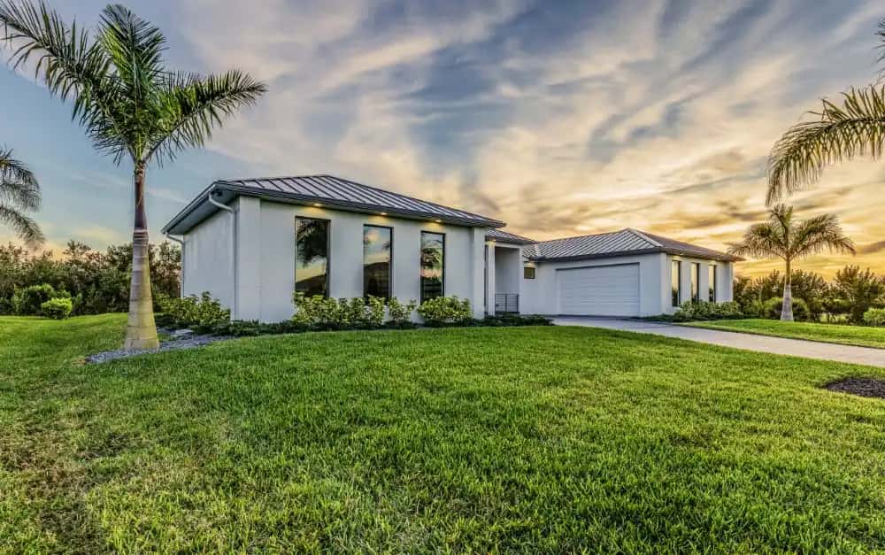 Modern Florida home with standing seam metal roof and impact windows