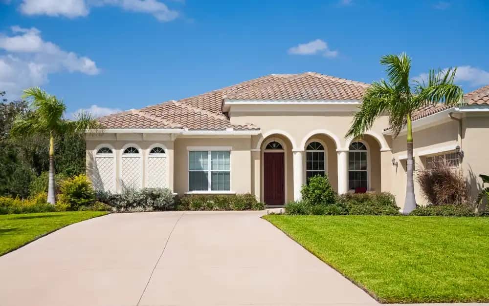 South Florida home with clay barrel tile roof and arched windows