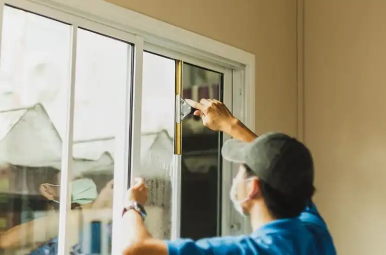 Technician installing impact window in South Florida home