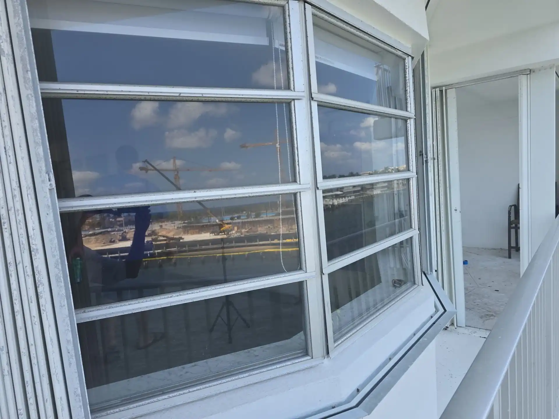 Multi-panel white impact window on Deerfield Beach high-rise balcony