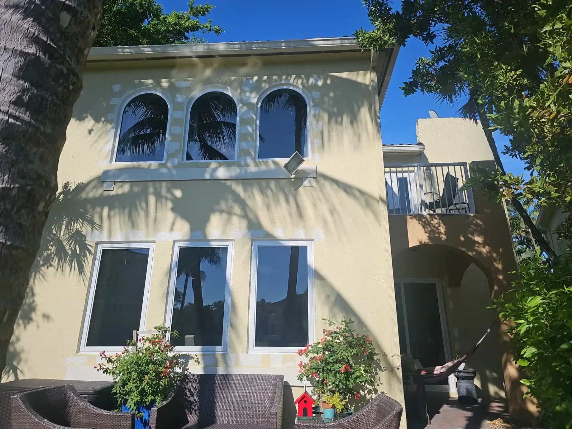 Impact windows installed on two-story Aventura Florida stucco home