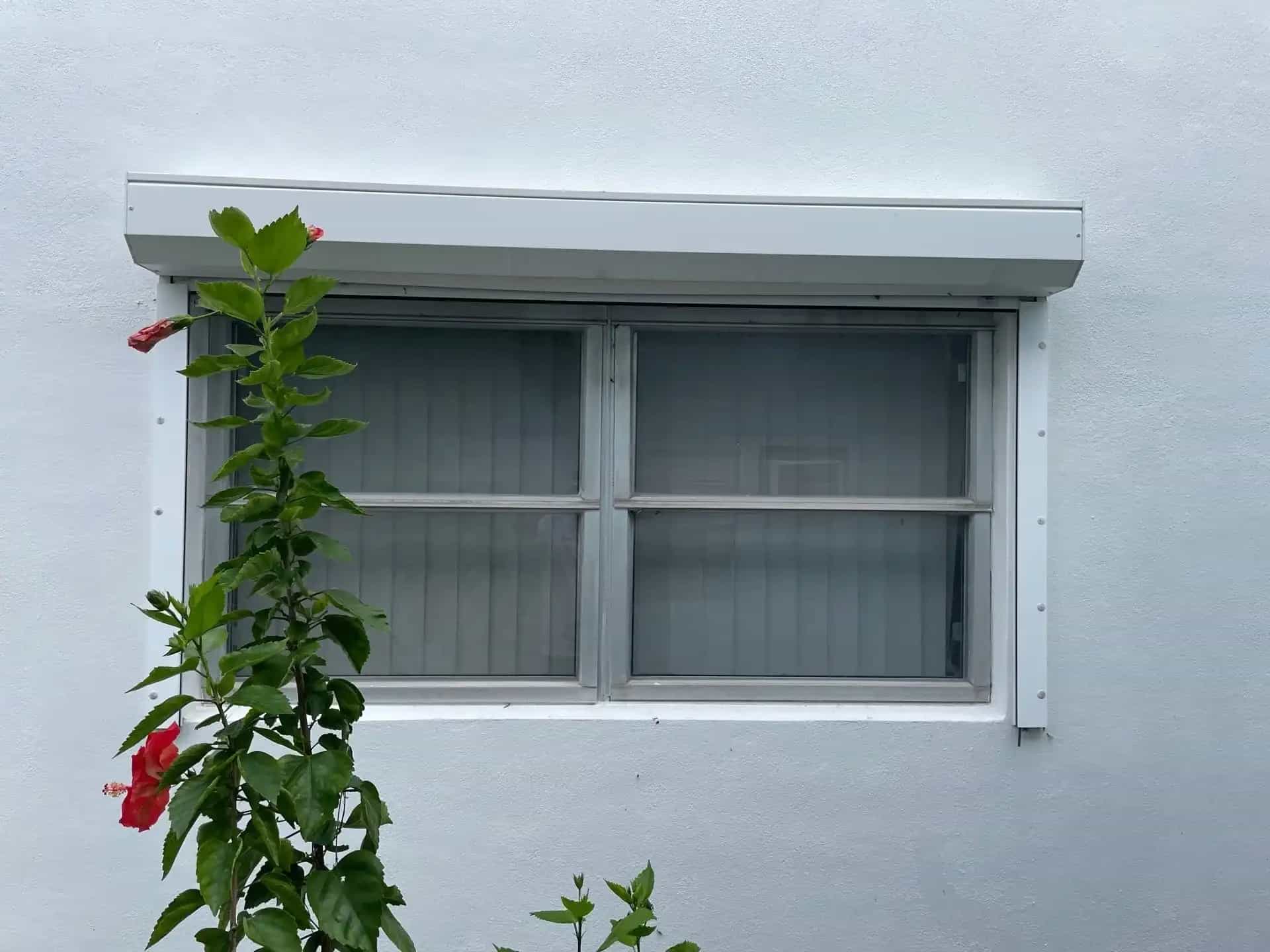 White impact sliding window installed on stucco home in Lake Worth Beach