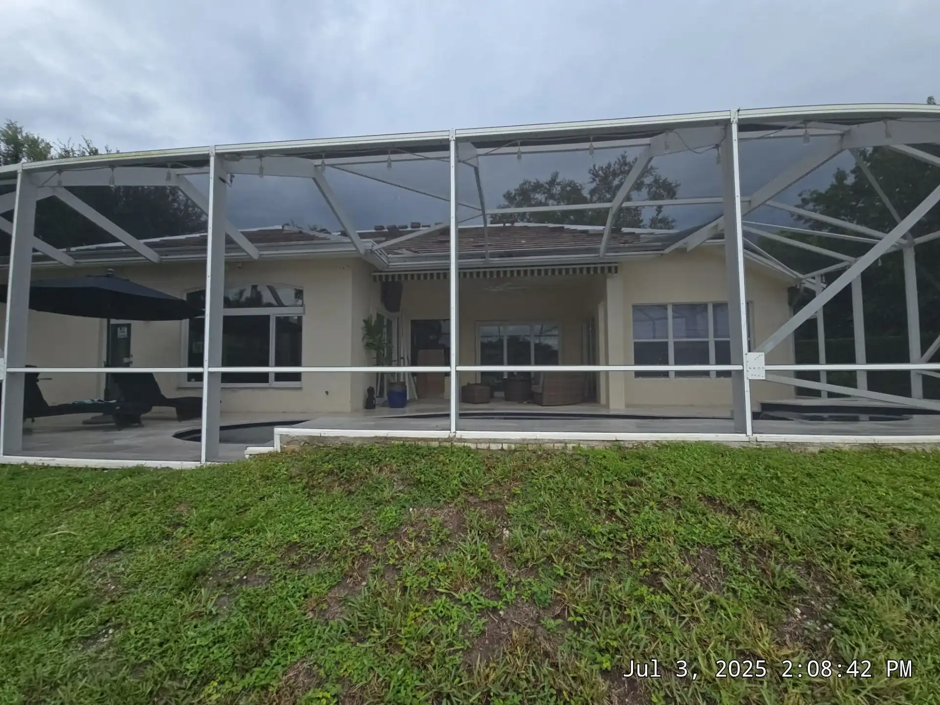 South Florida home with pool screen enclosure and impact windows
