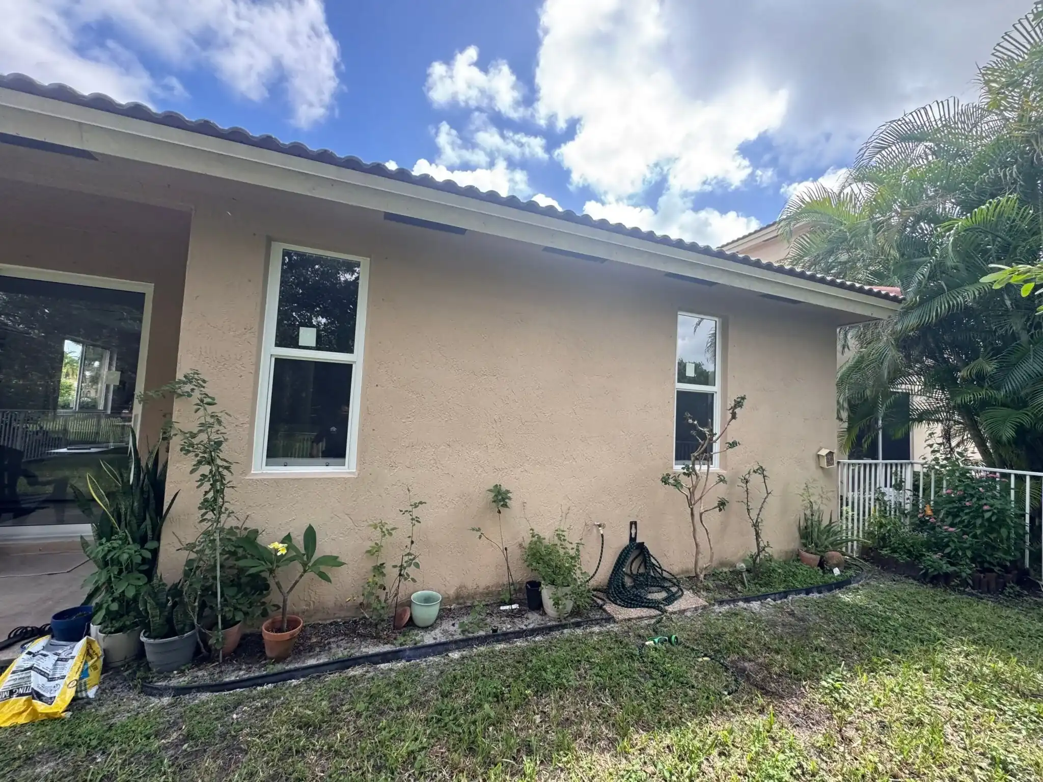 New white impact windows on stucco home exterior Coconut Creek Florida