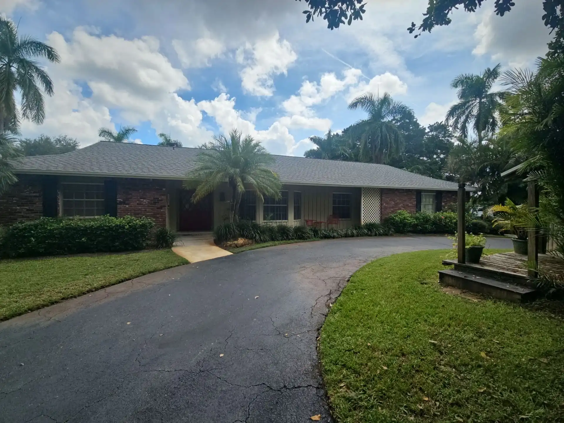 Brick ranch home with asphalt shingle roof in Jupiter Florida