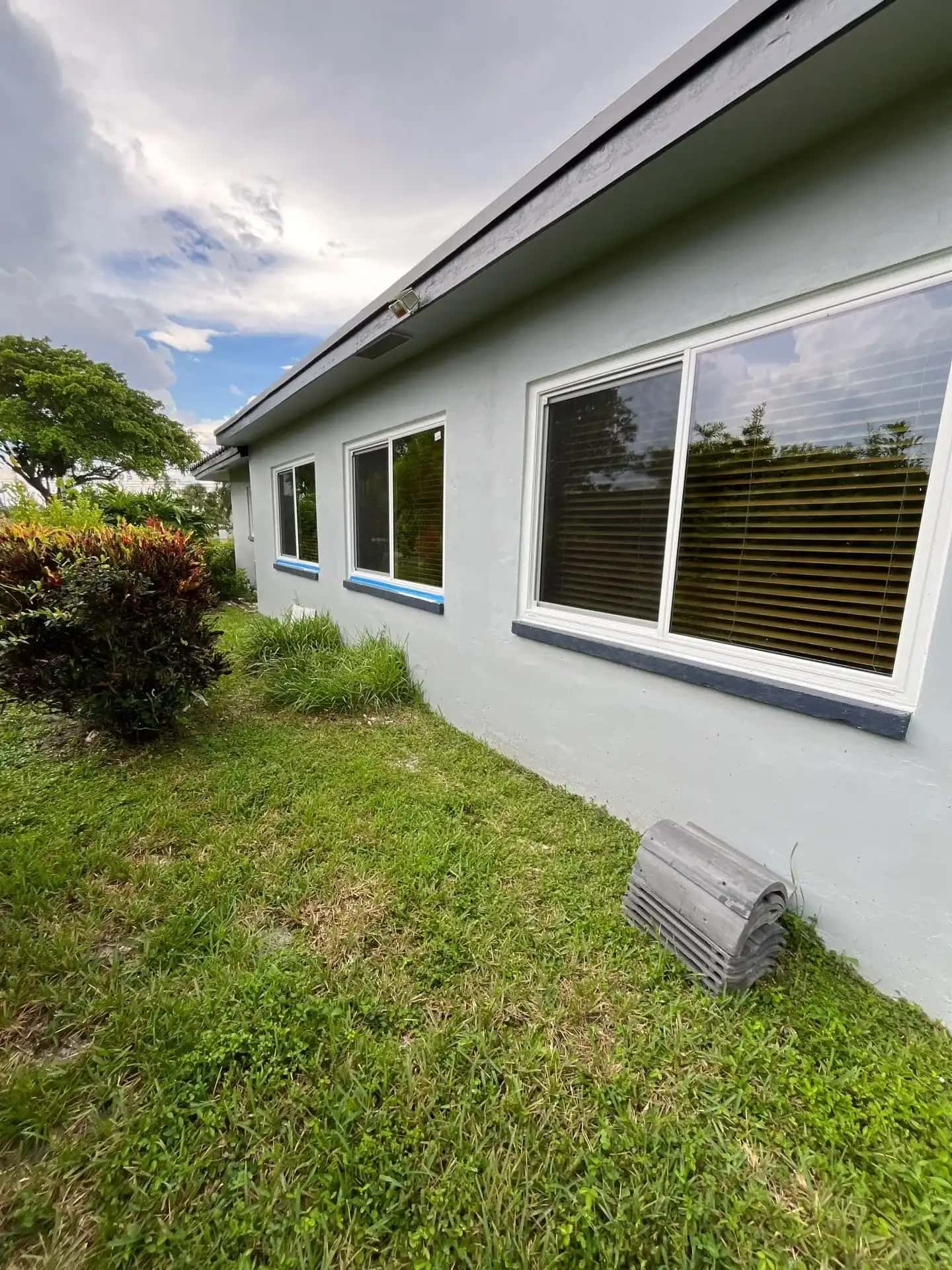 Newly installed impact windows on grey stucco home in Tamarac Florida