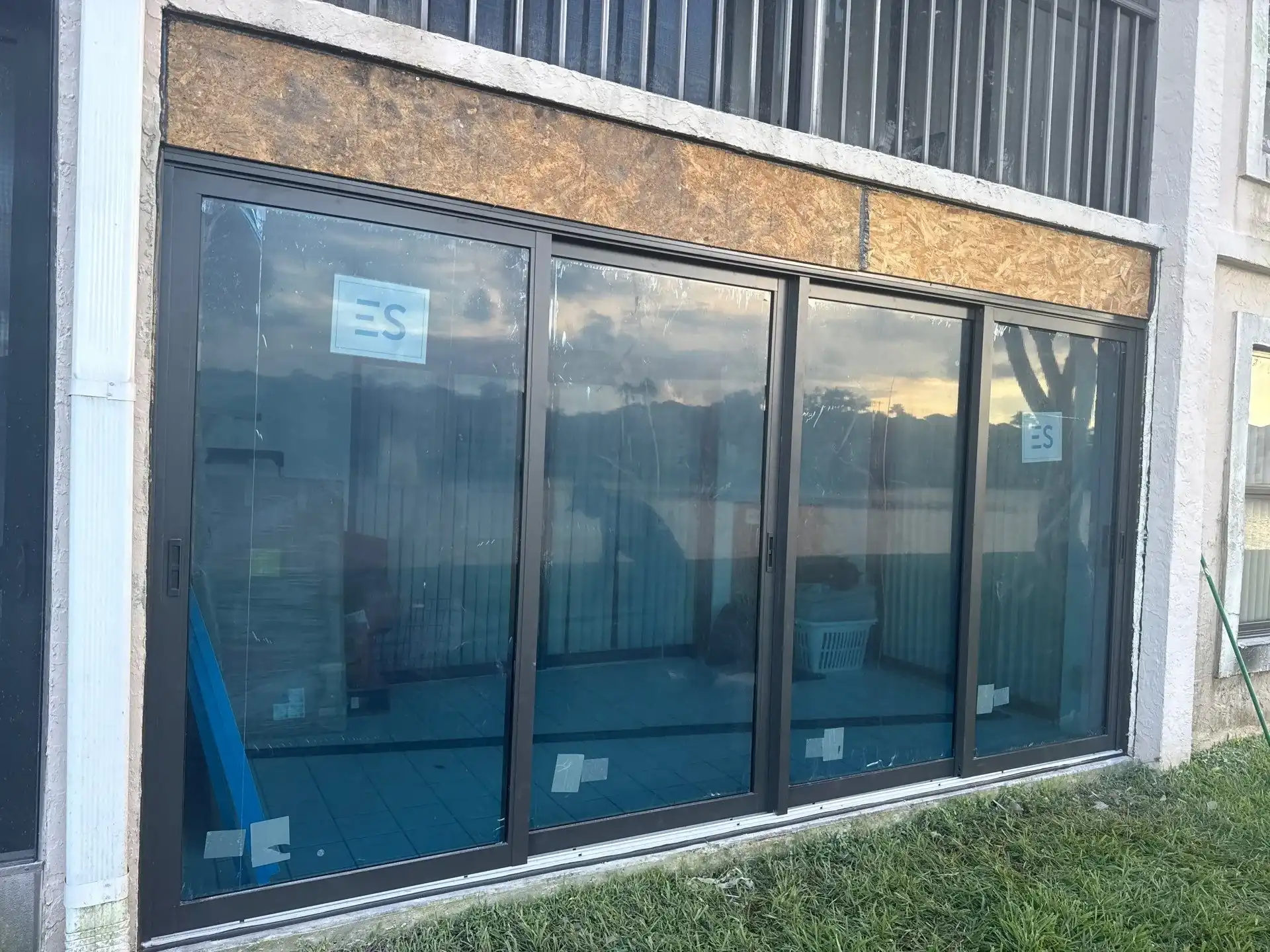 Four-panel impact sliding glass door installed on a condo