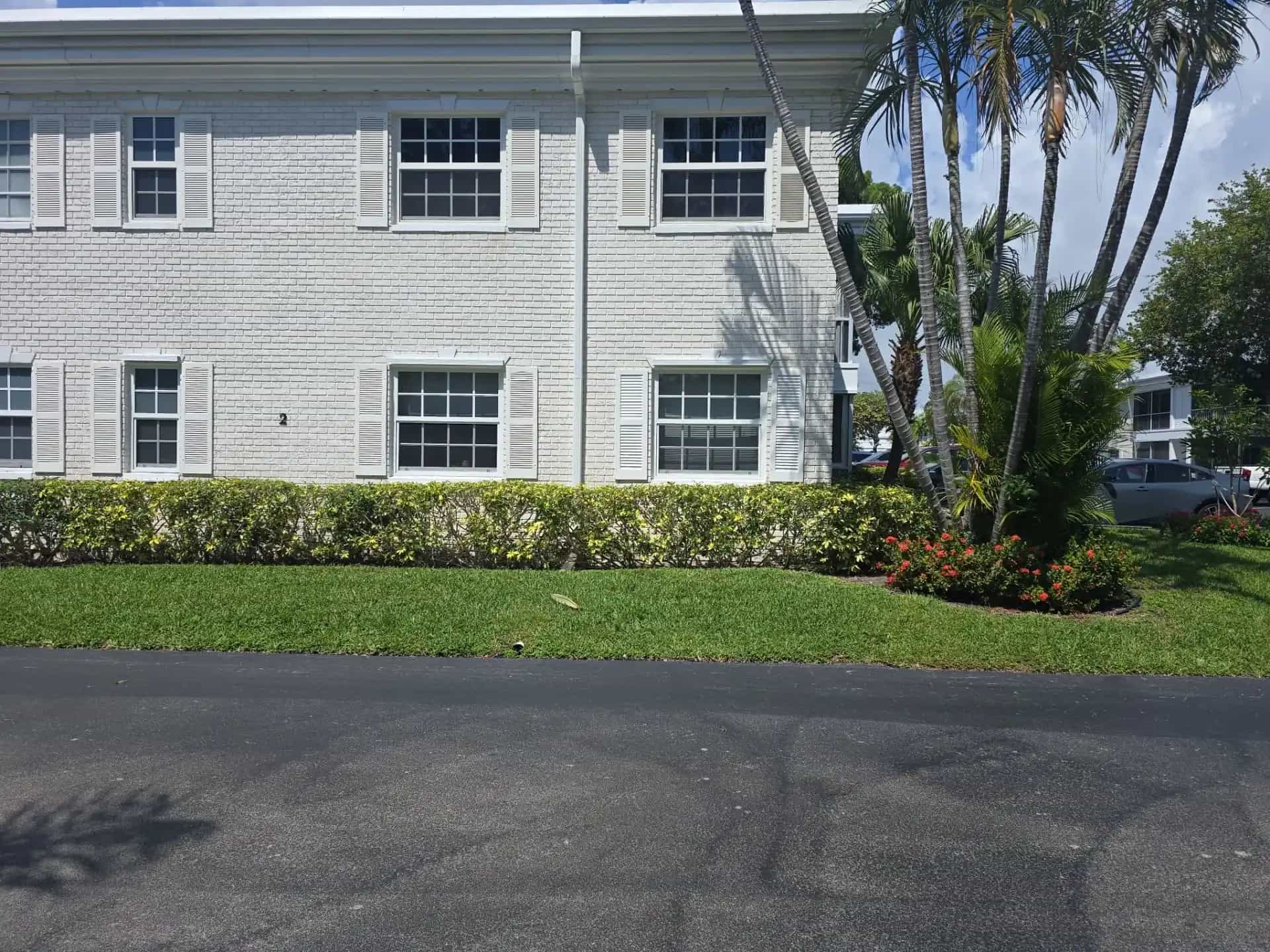 Two-story South Florida condo building with impact windows and shutters