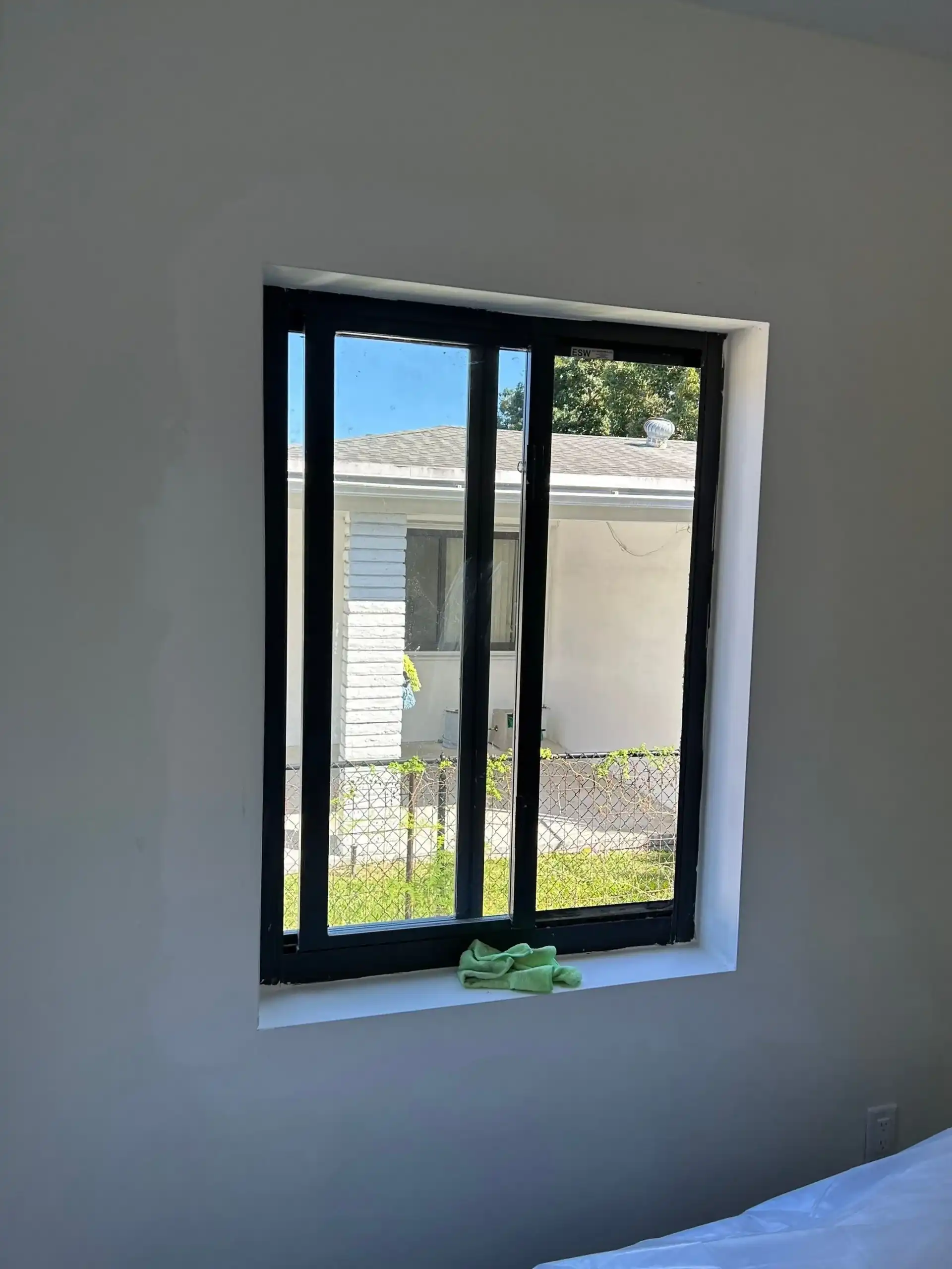 Black frame impact window installed in Kendall FL bedroom