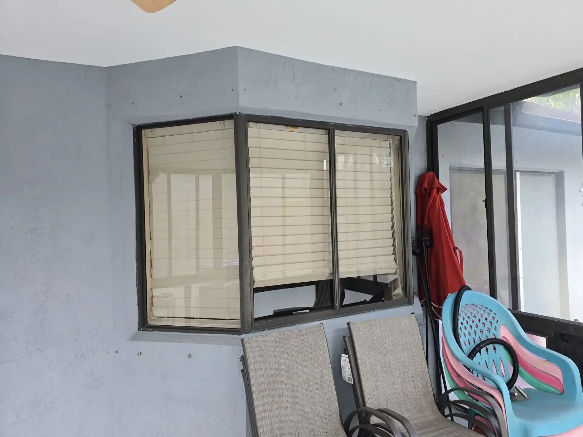 Impact window installation on gray stucco home in Margate Florida