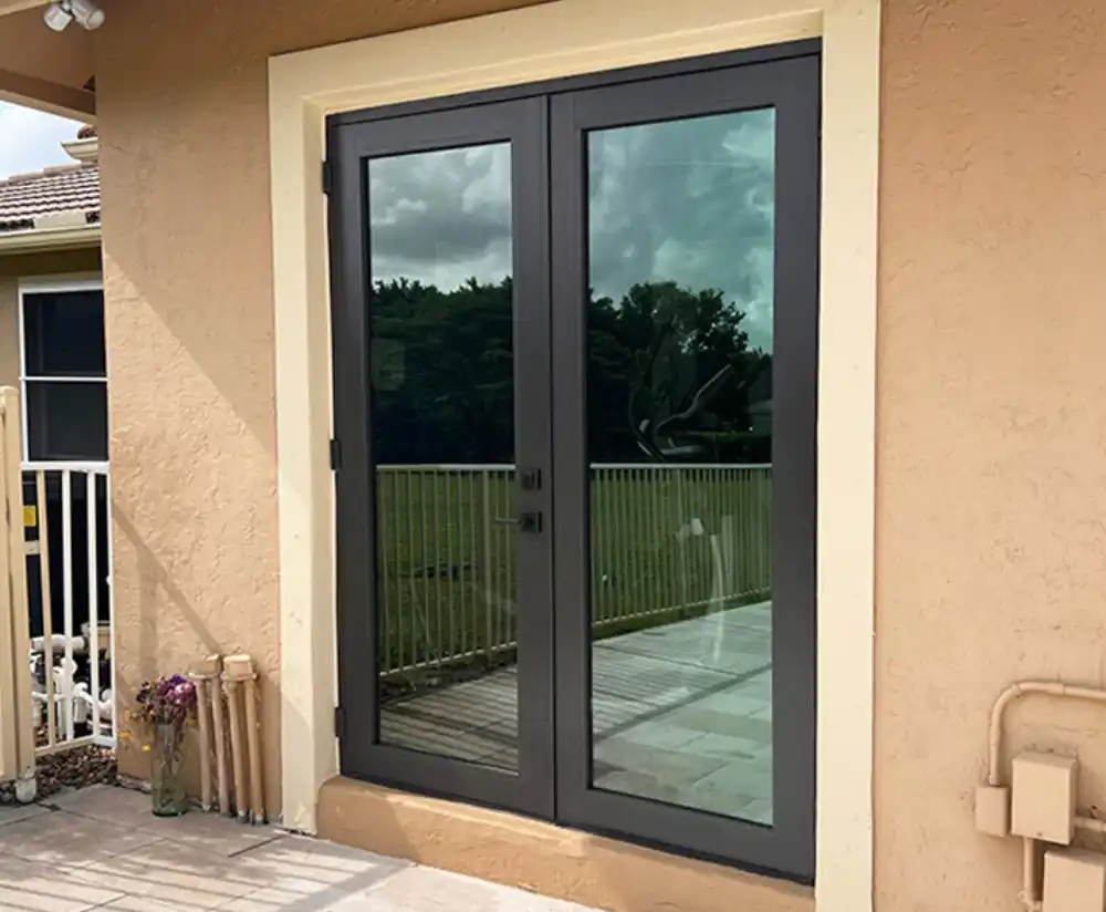 Black-frame impact French doors at the same opening