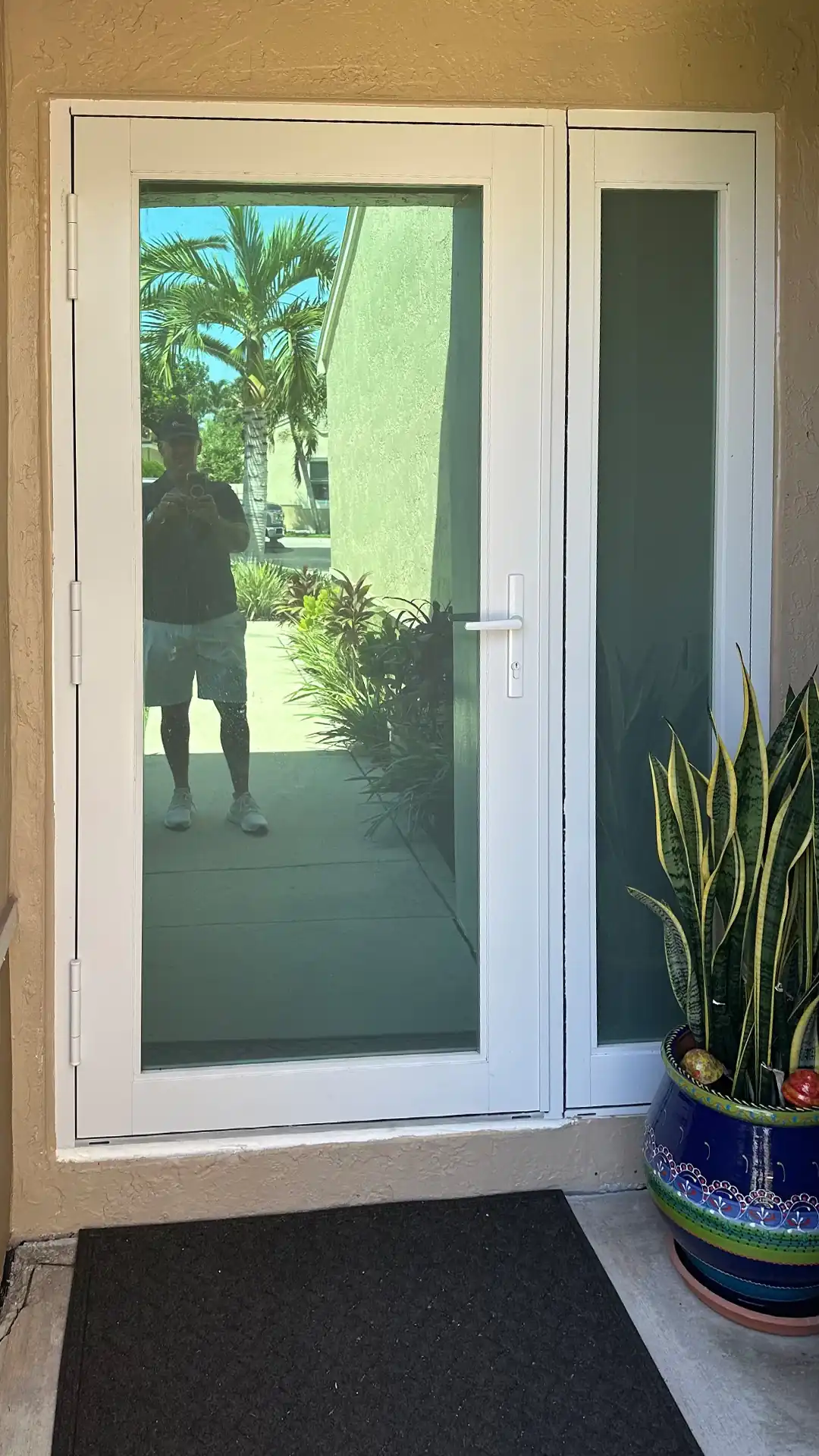 White impact entry door with sidelite installed at South Florida home